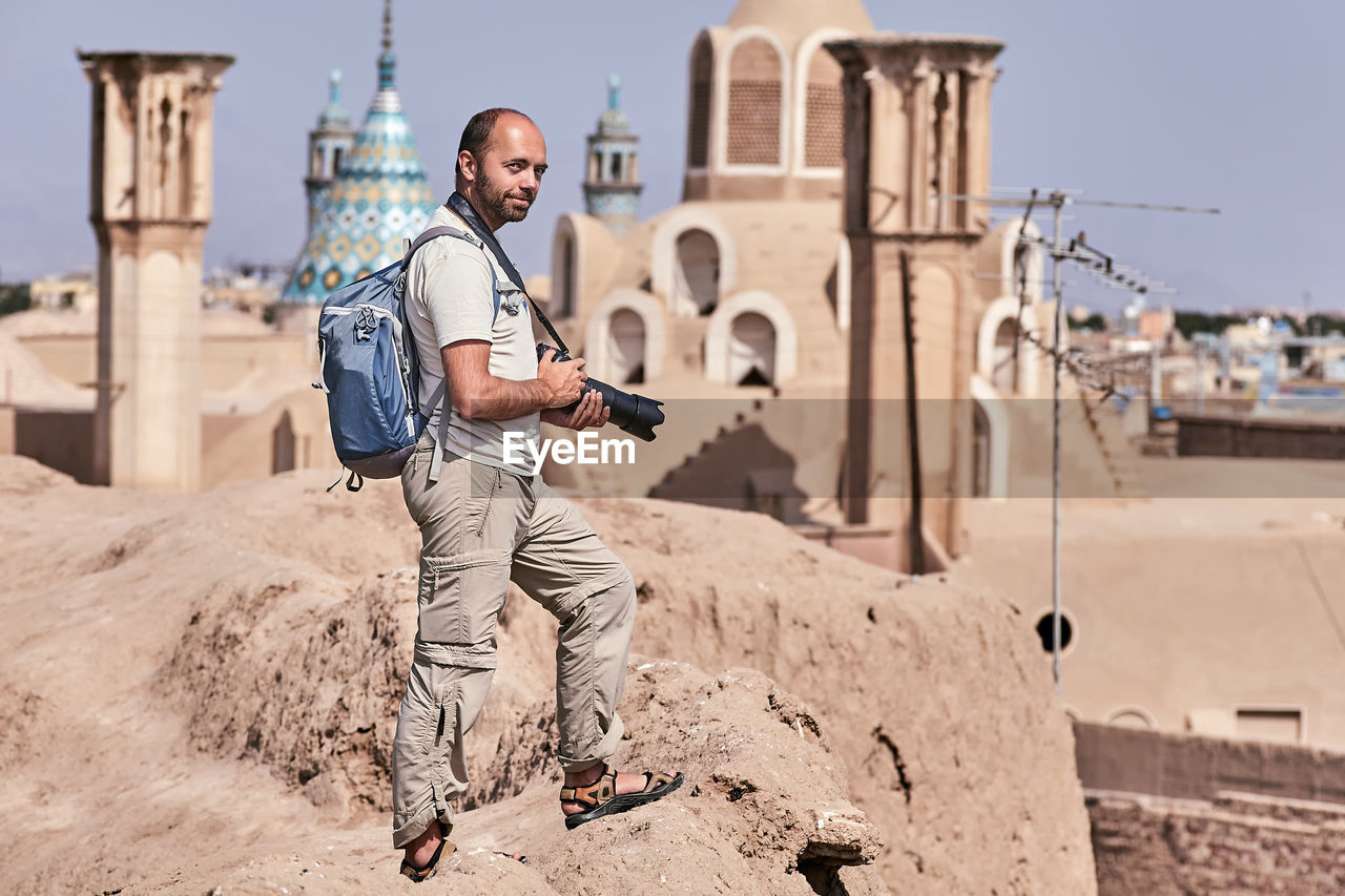 Man with camera at historic place