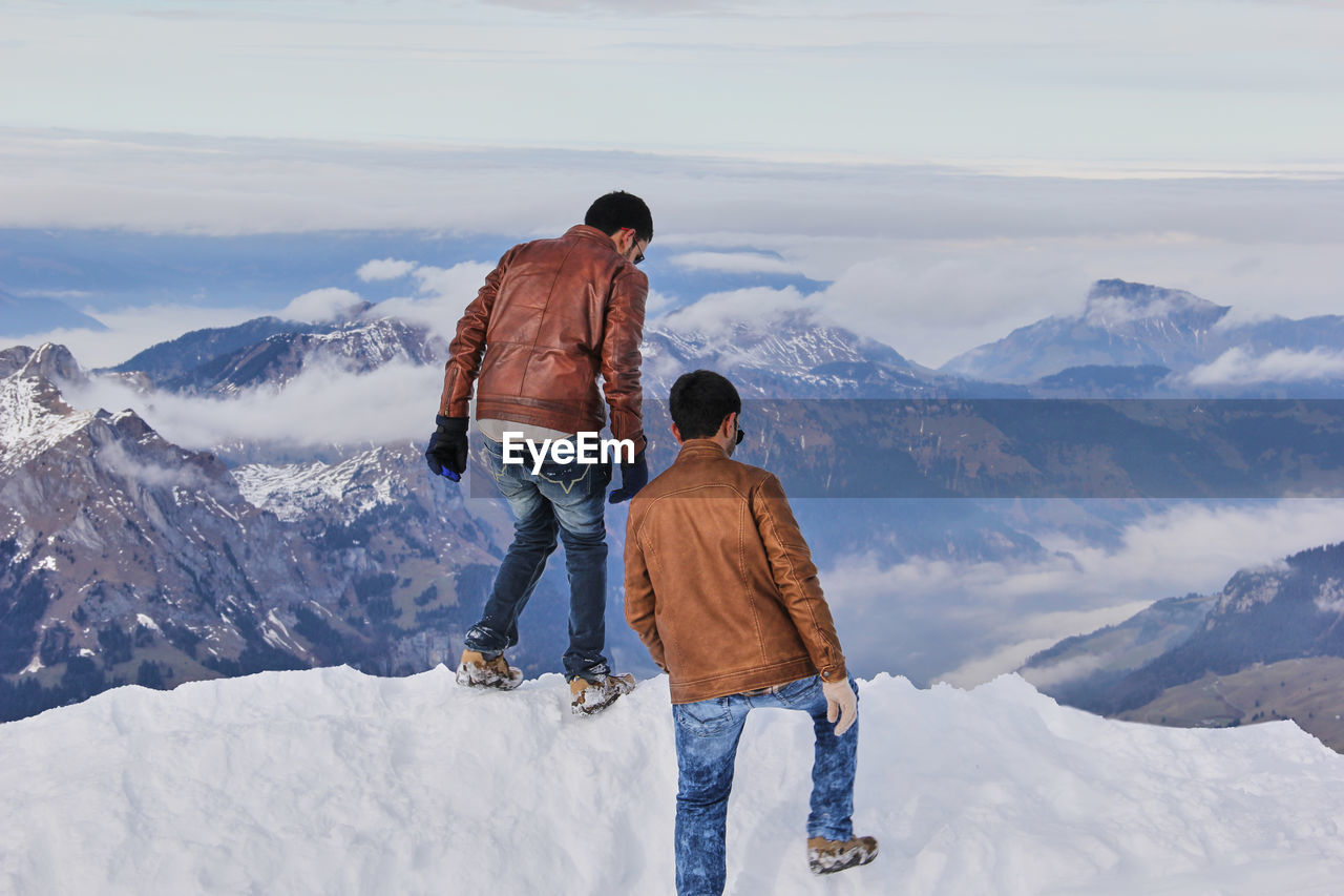 Rear view of two men on the top of a mountain