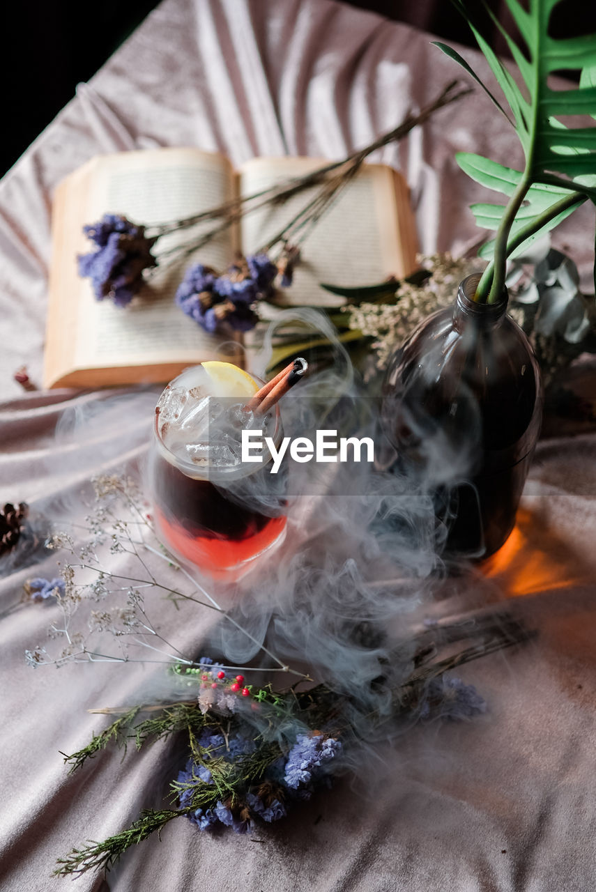 High angle view of smoke emitting from drink on table