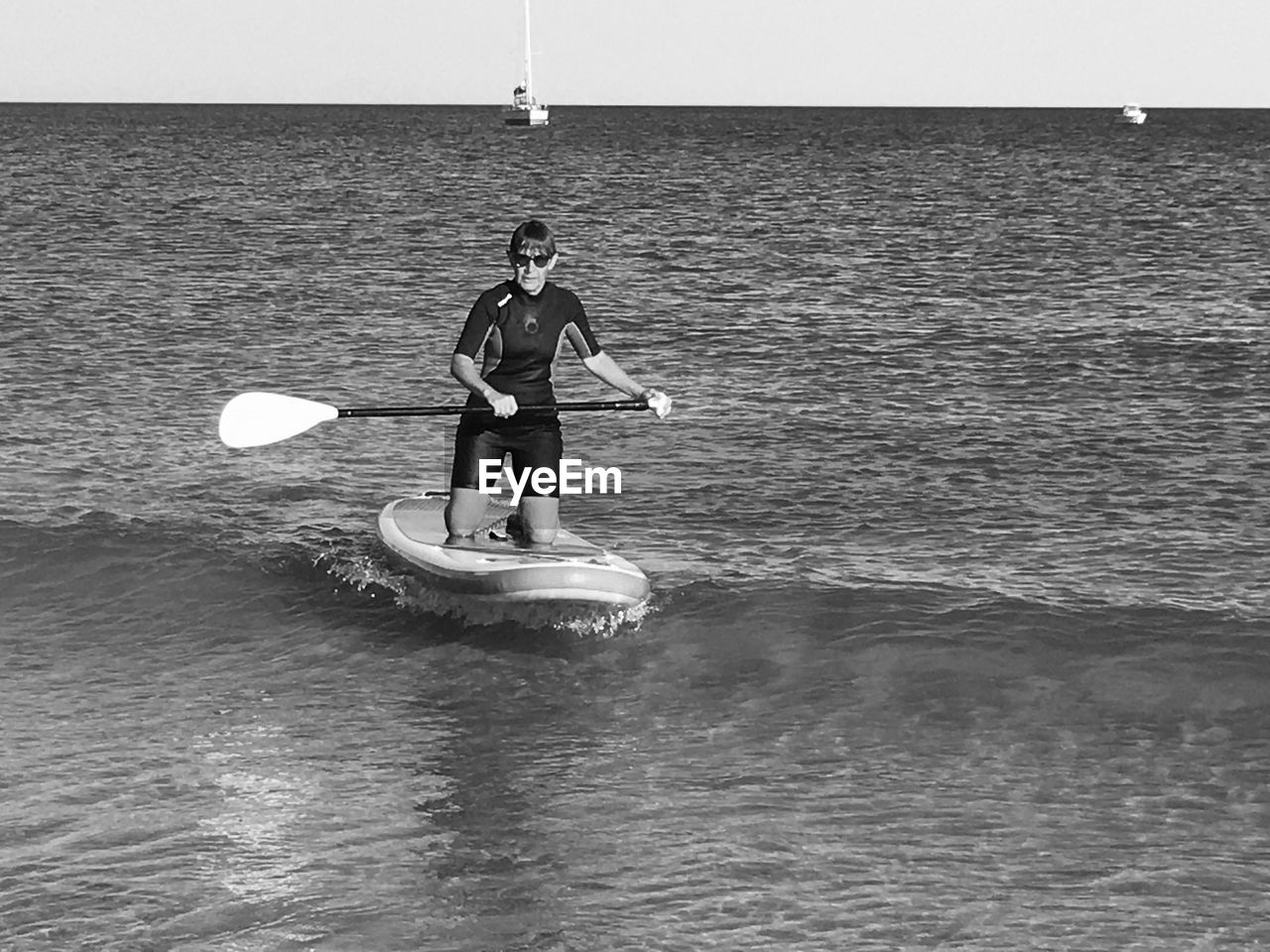 MAN STANDING ON SEA AGAINST SKY