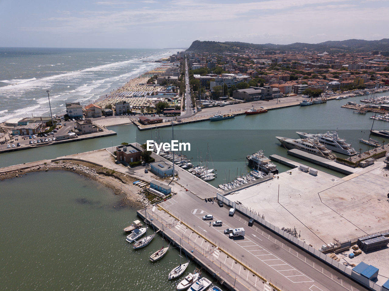 High angle view of cityscape by sea against sky