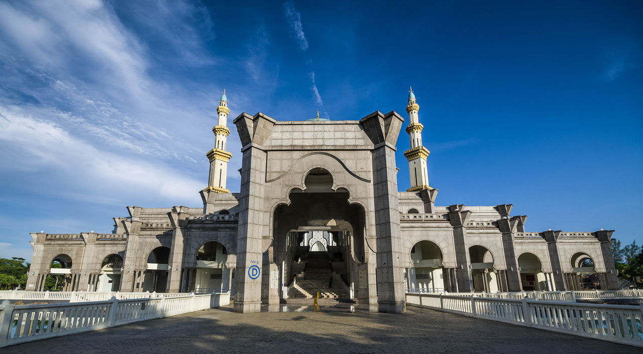 LOW ANGLE VIEW OF BUILT STRUCTURE AGAINST BLUE SKY