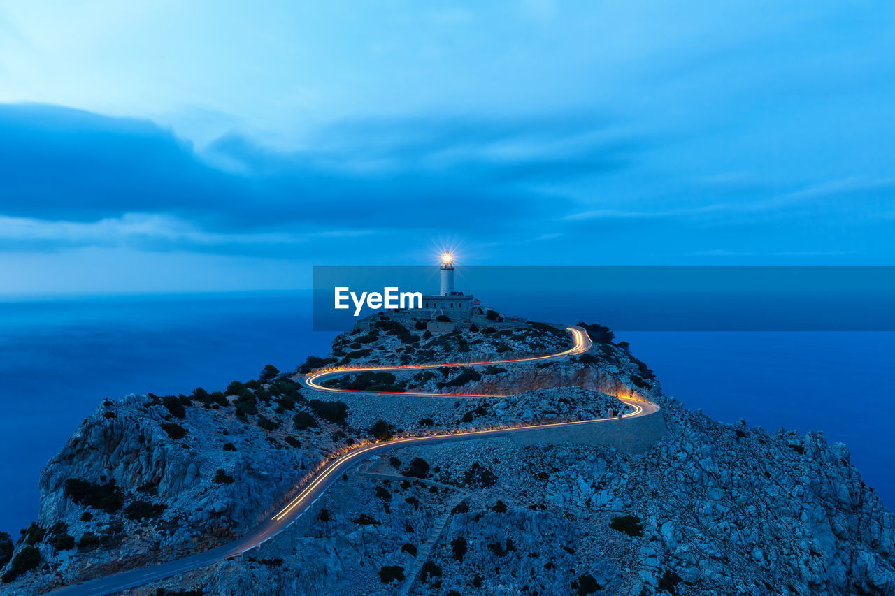 LIGHTHOUSE AMIDST SEA AGAINST SKY