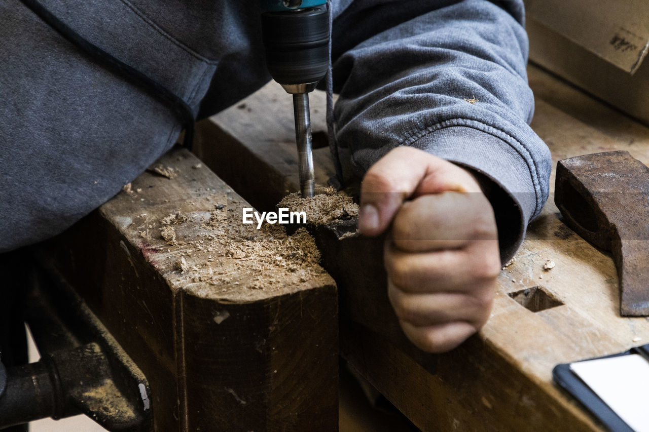 Close up of drilling a rusty axe for restoring