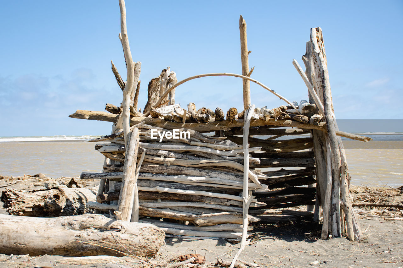 STACK OF FIREWOOD ON BEACH