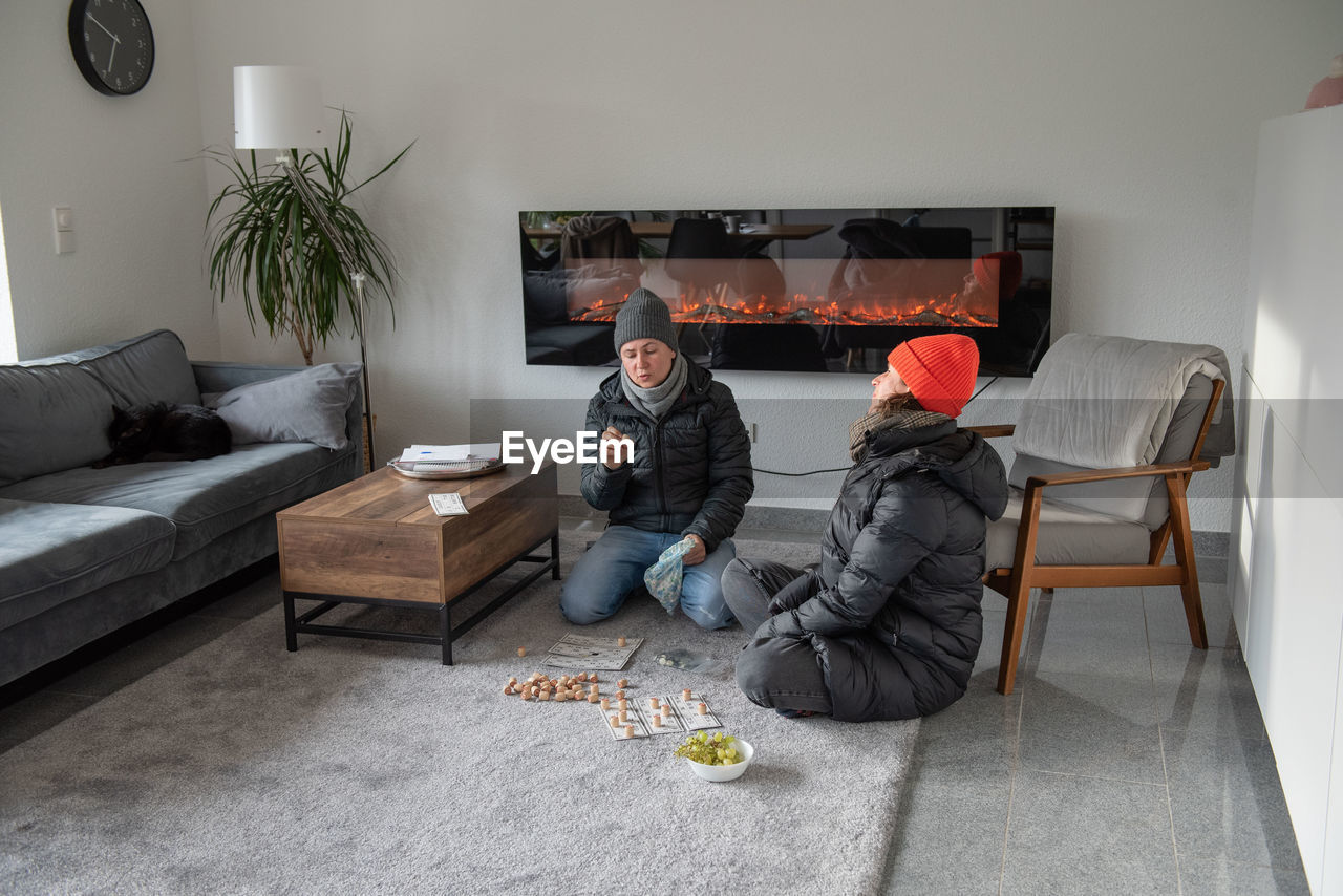 Family at home in winter clothes it's cold they freeze save energy
