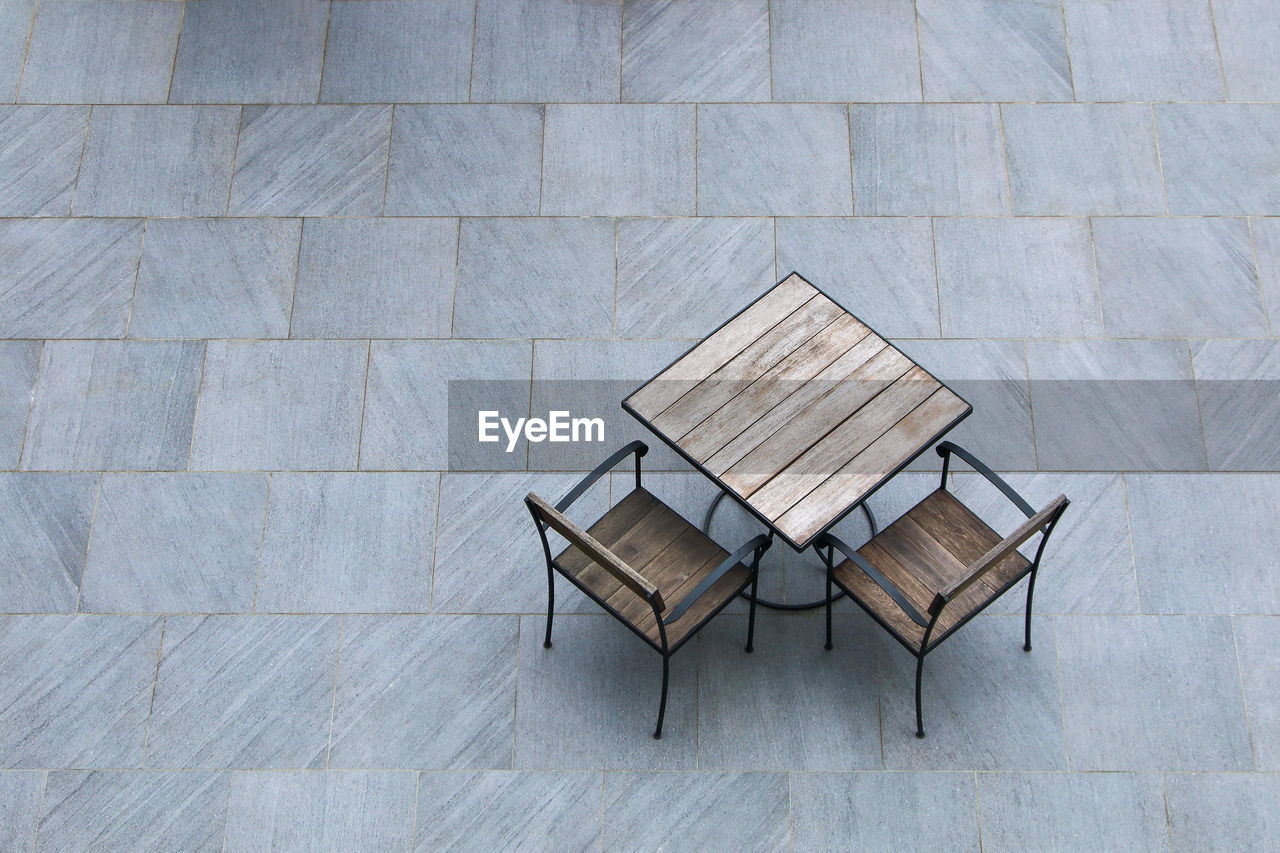 High angle view of chairs and table on floor