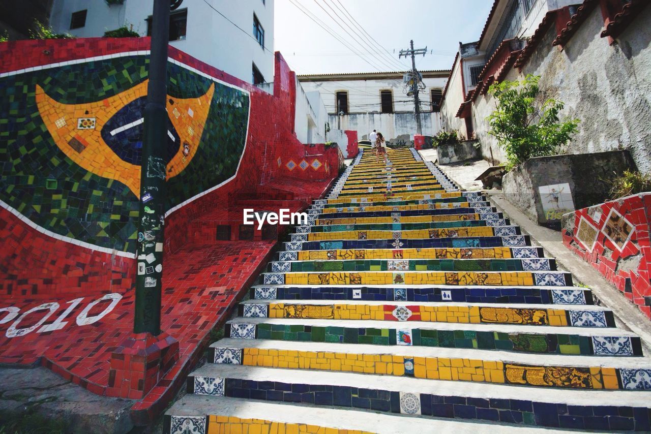 Low angle view of stairs along graffiti wall