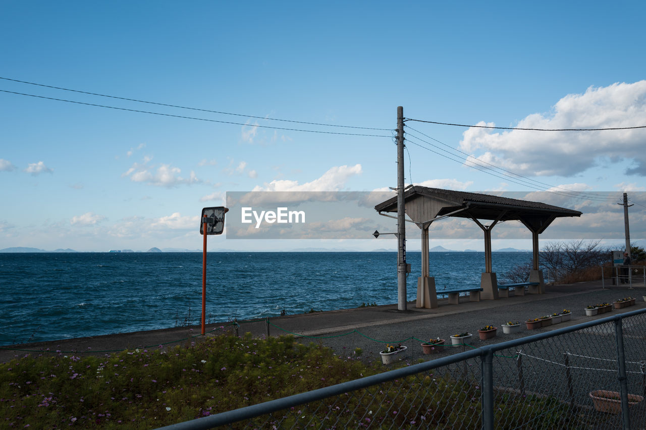 sky, water, sea, nature, coast, cloud, architecture, ocean, transportation, cable, blue, horizon, horizon over water, no people, beach, built structure, day, electricity, scenics - nature, land, beauty in nature, outdoors, travel, road, travel destinations, tranquility, railing, shore, walkway, technology, city, vacation, tranquil scene