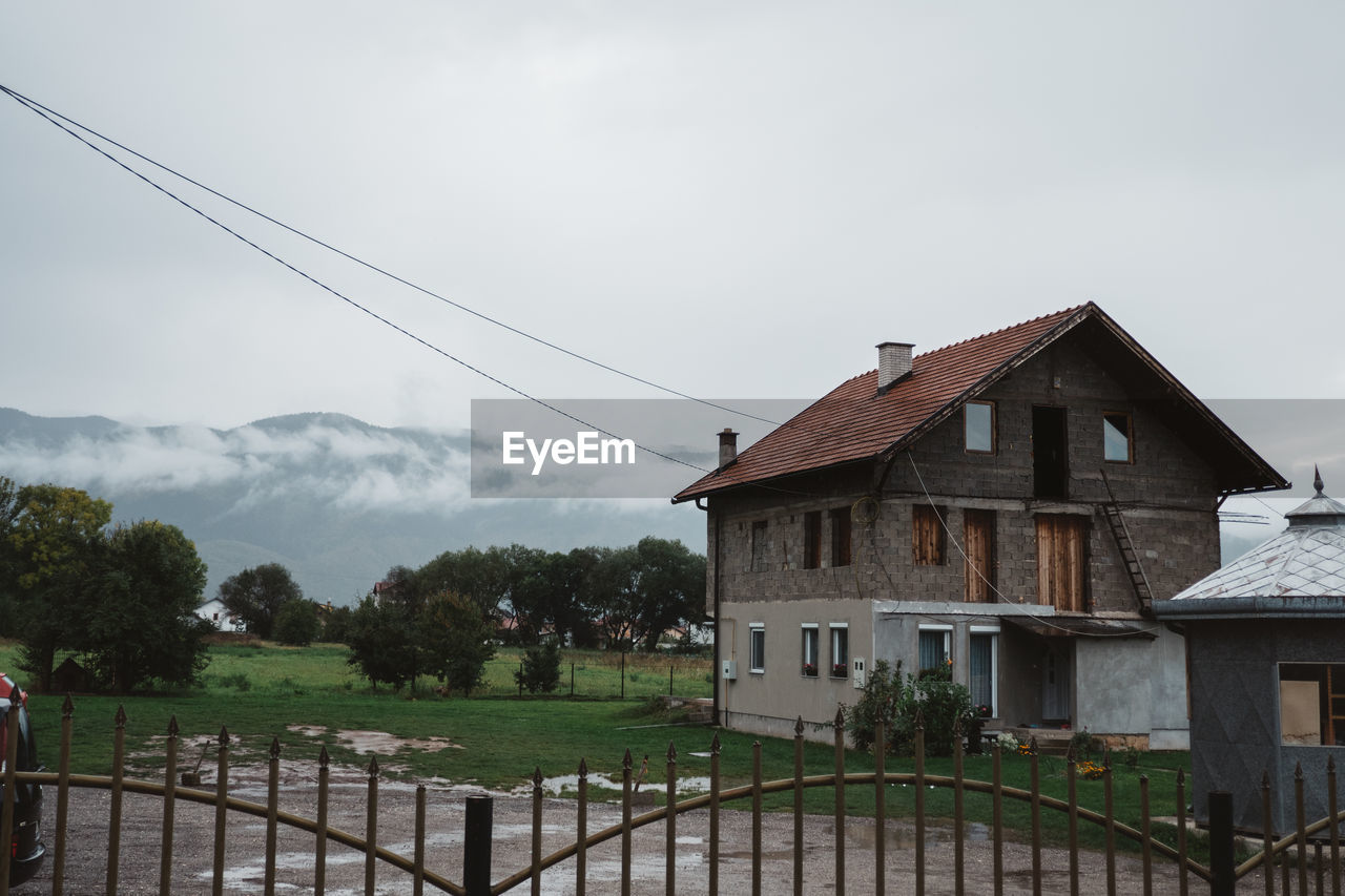 HOUSES AGAINST SKY