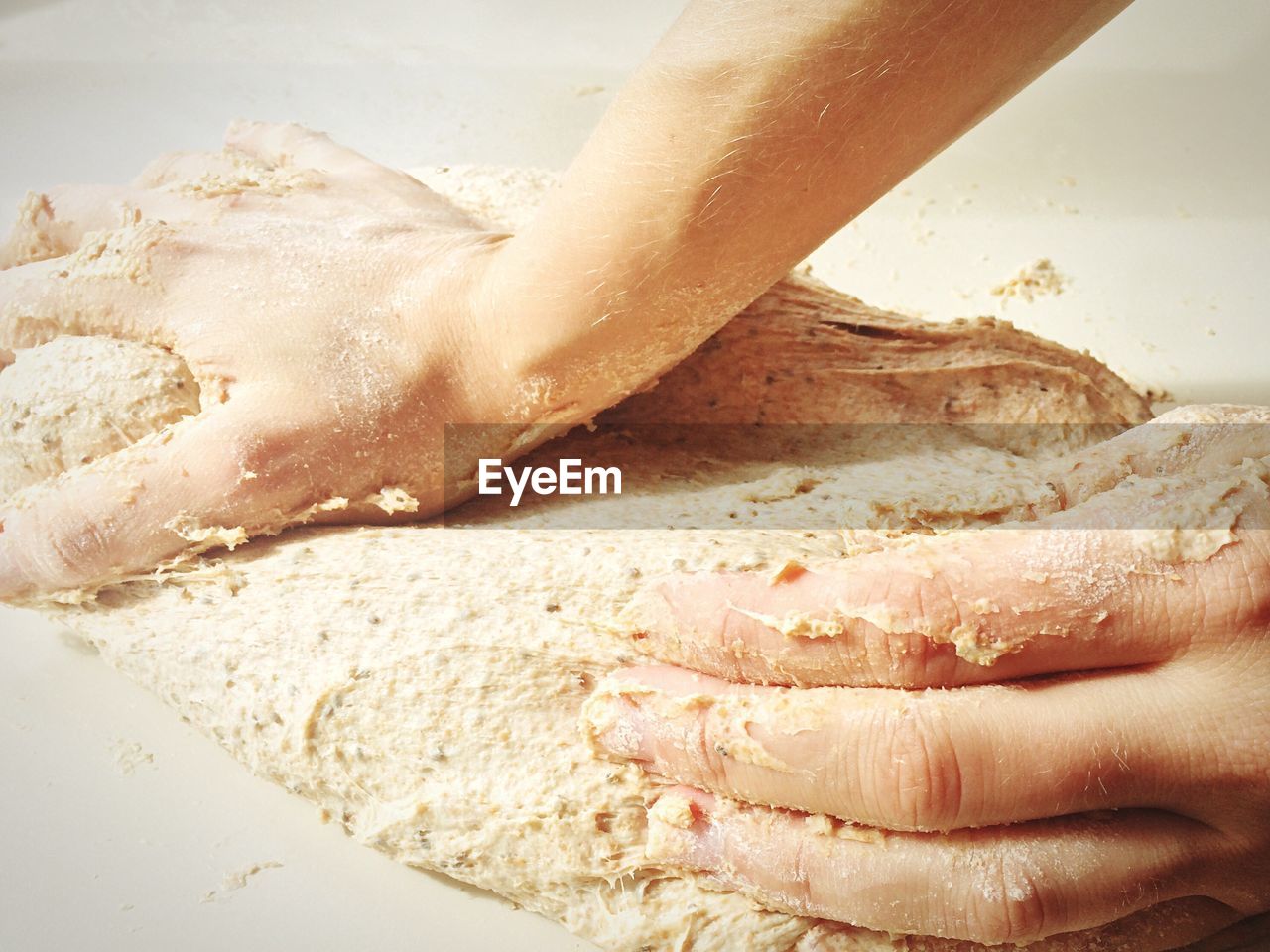 Cropped image of person kneading dough