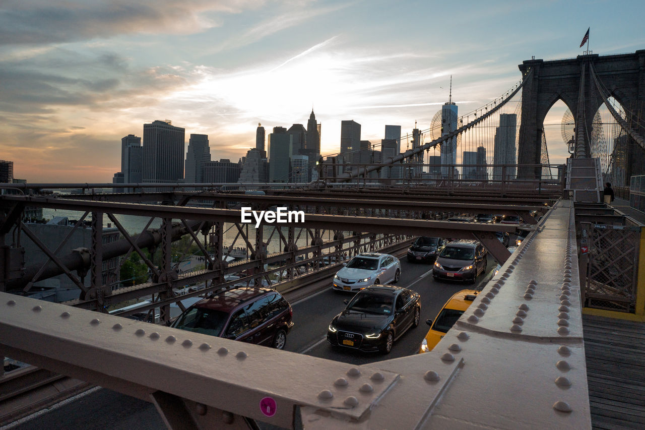 Vehicles moving under brooklyn bridge road over east river