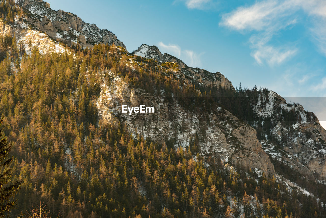 Low angle view of rocky mountains against sky