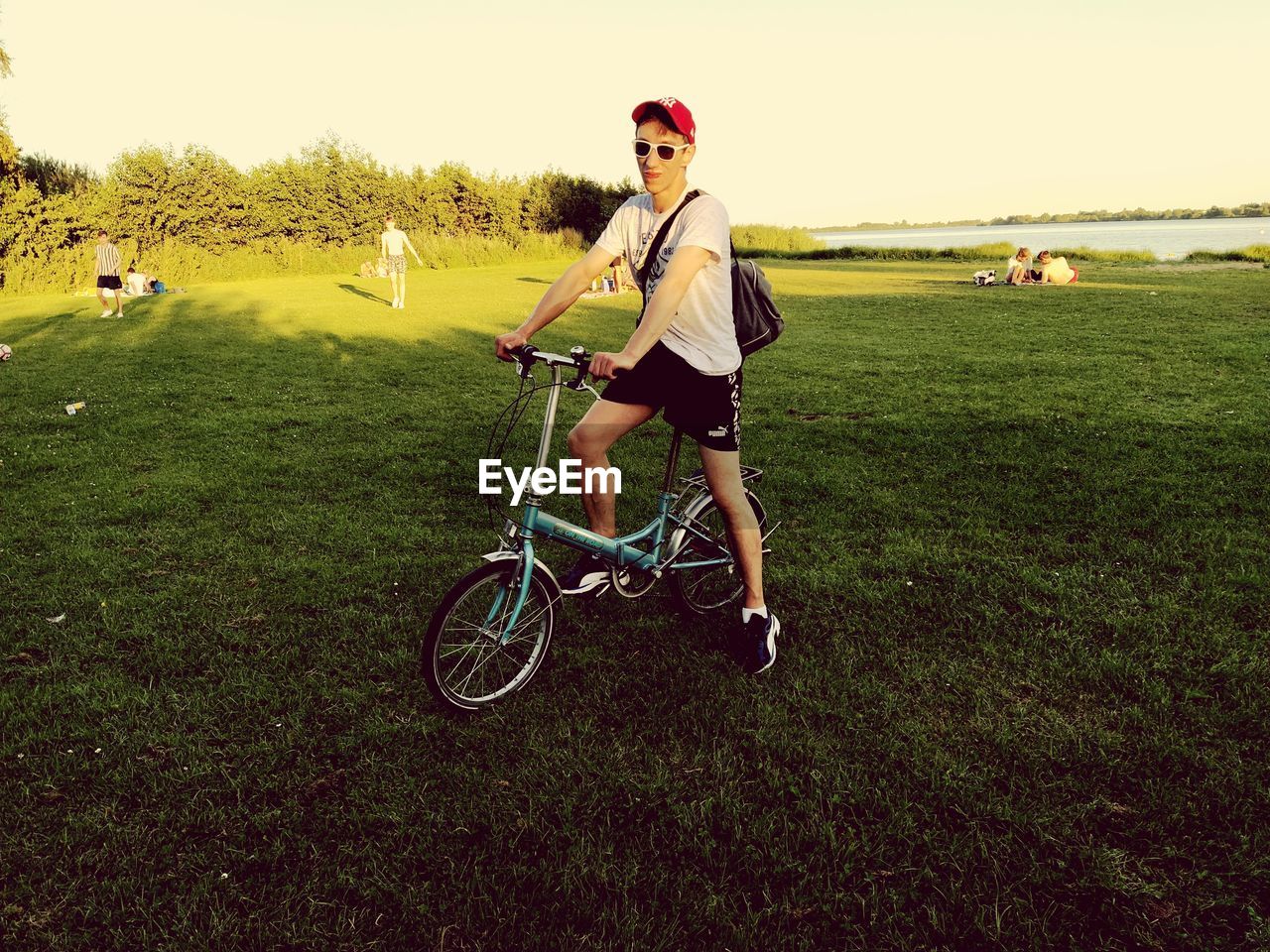 BOY RIDING BICYCLE ON FIELD