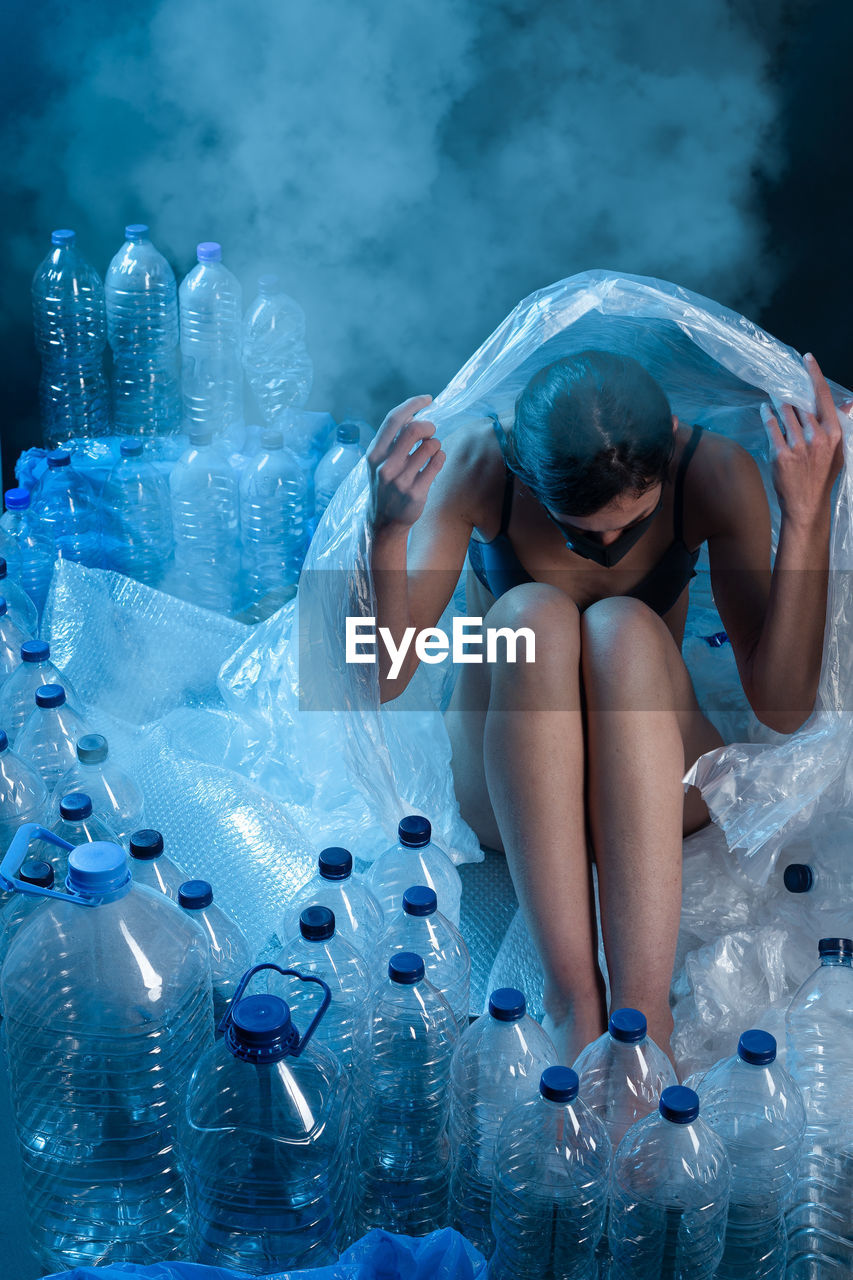 Woman protecting herself from plastic format. concept of recycling plastic and ecology.