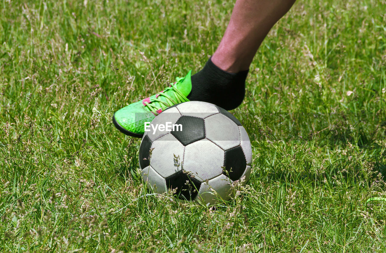 Foot in a football beating on a soccer ball