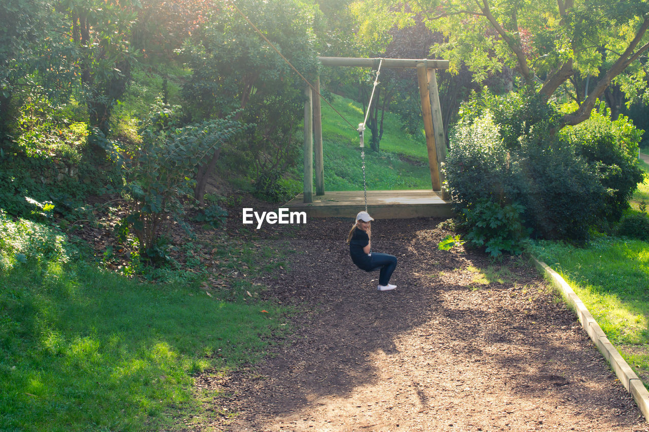 Girl swinging in park