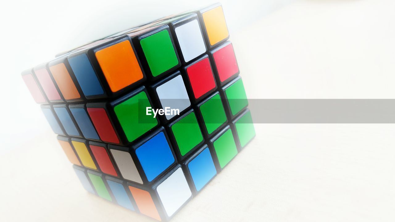 Close-up of puzzle cube against white background