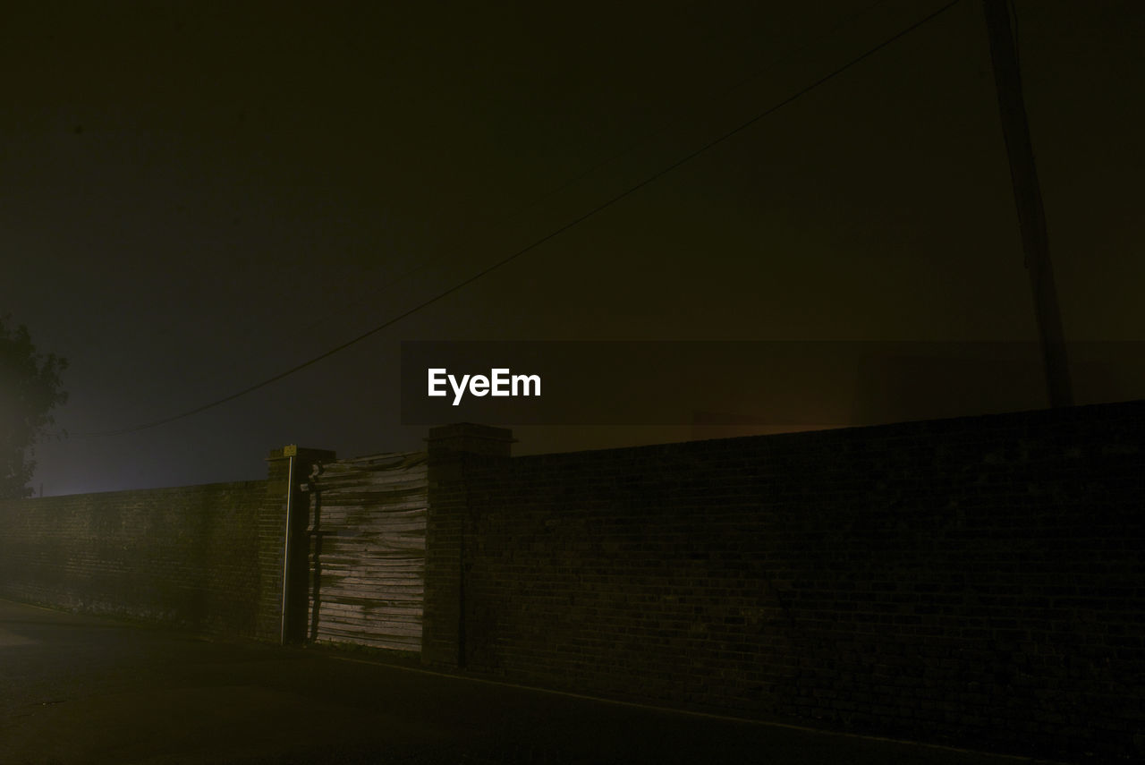 Wall against clear sky at night