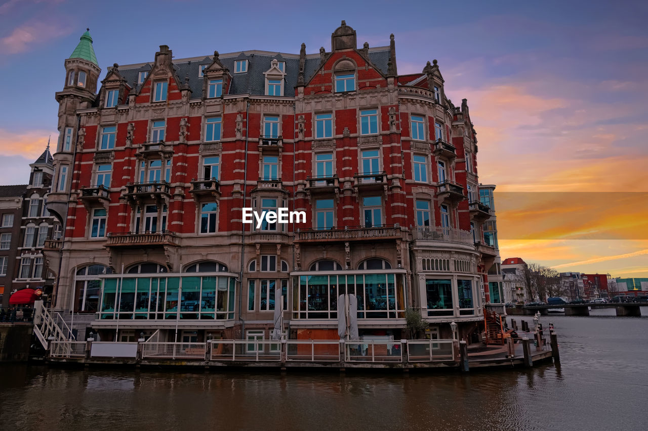 BUILDING AGAINST SKY AT SUNSET