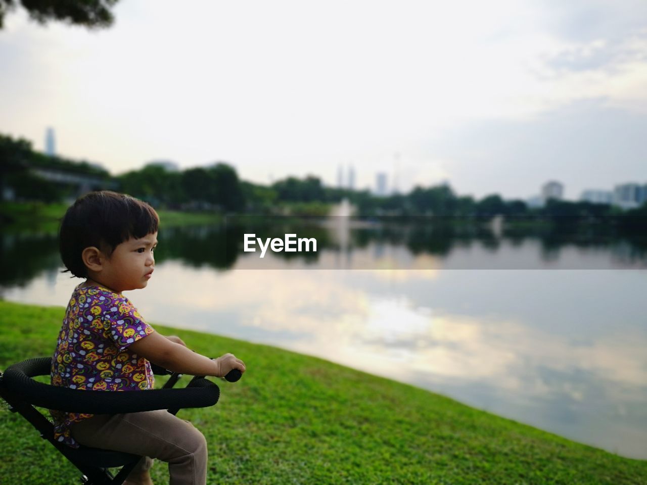 SIDE VIEW OF CUTE BOY IN LAKE