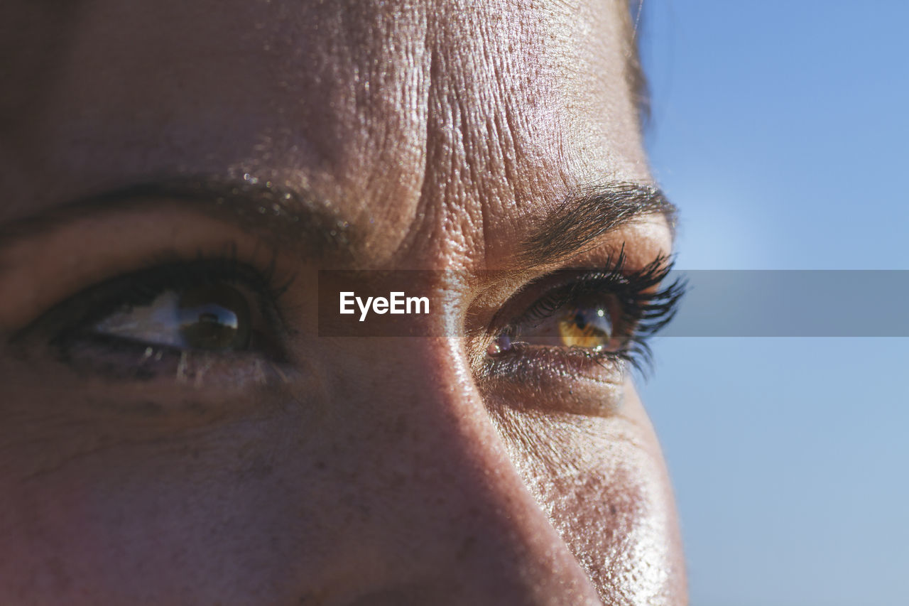 Portrait of a young woman with green eyes looking at the horizon on a