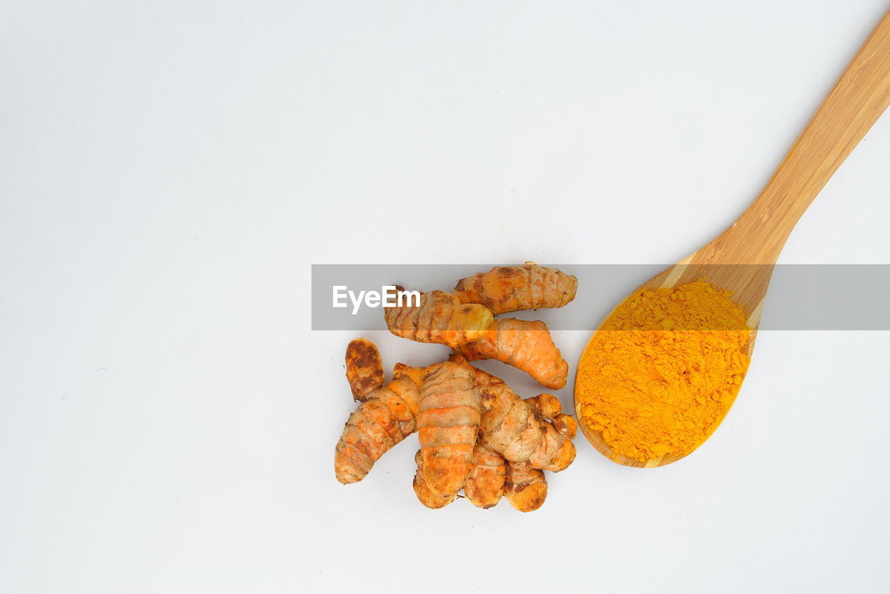 HIGH ANGLE VIEW OF ORANGE LEAF ON WHITE BACKGROUND