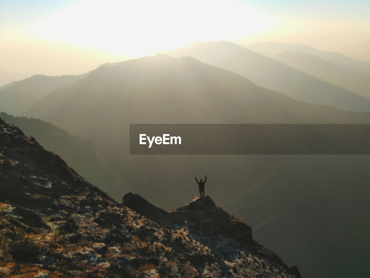 Scenic view of silhouette mountains at sunset