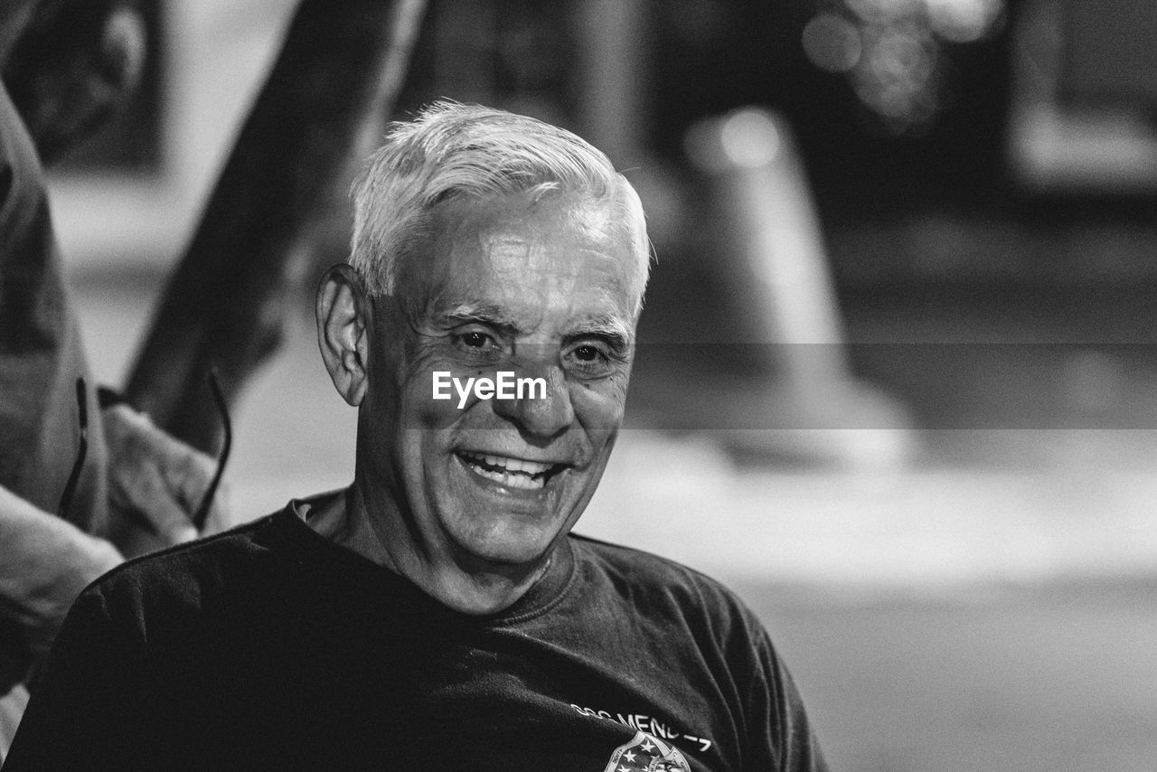 PORTRAIT OF SMILING MAN OUTDOORS