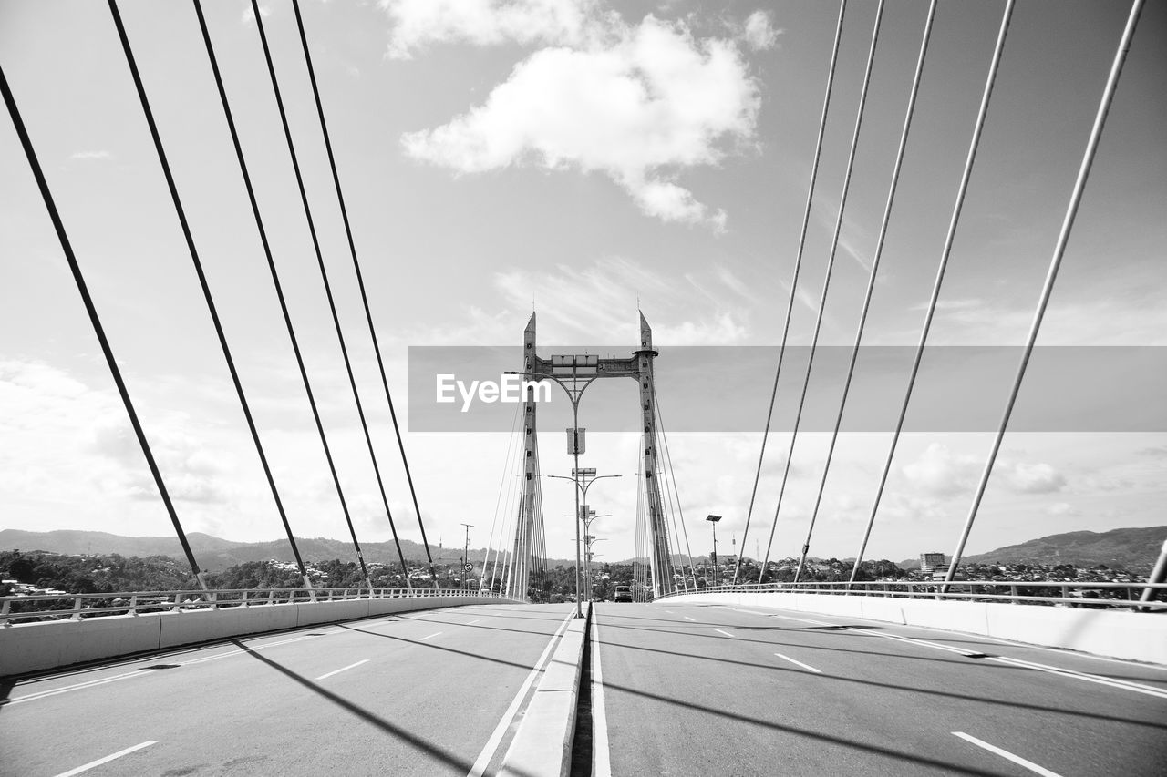 View of suspension bridge against cloudy sky