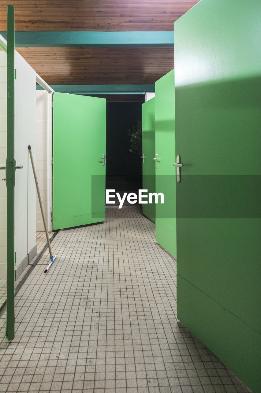 Green doors of toilet in building