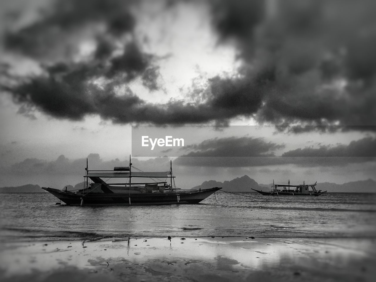 BOATS MOORED ON SEA