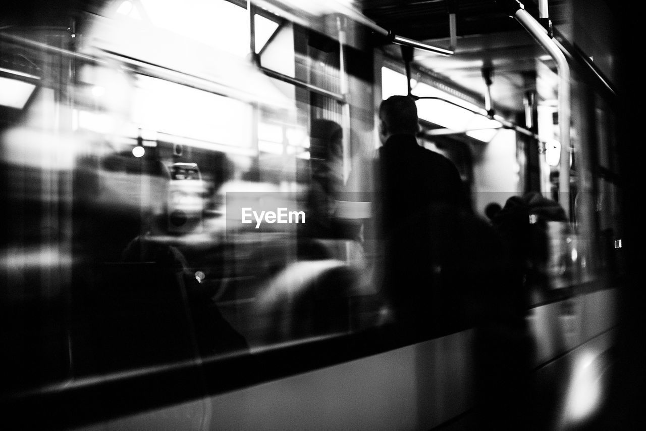 Blurred motion of people and train at railroad station platform