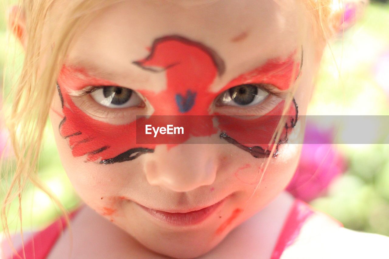 Close-up portrait of smiling girl with face paint