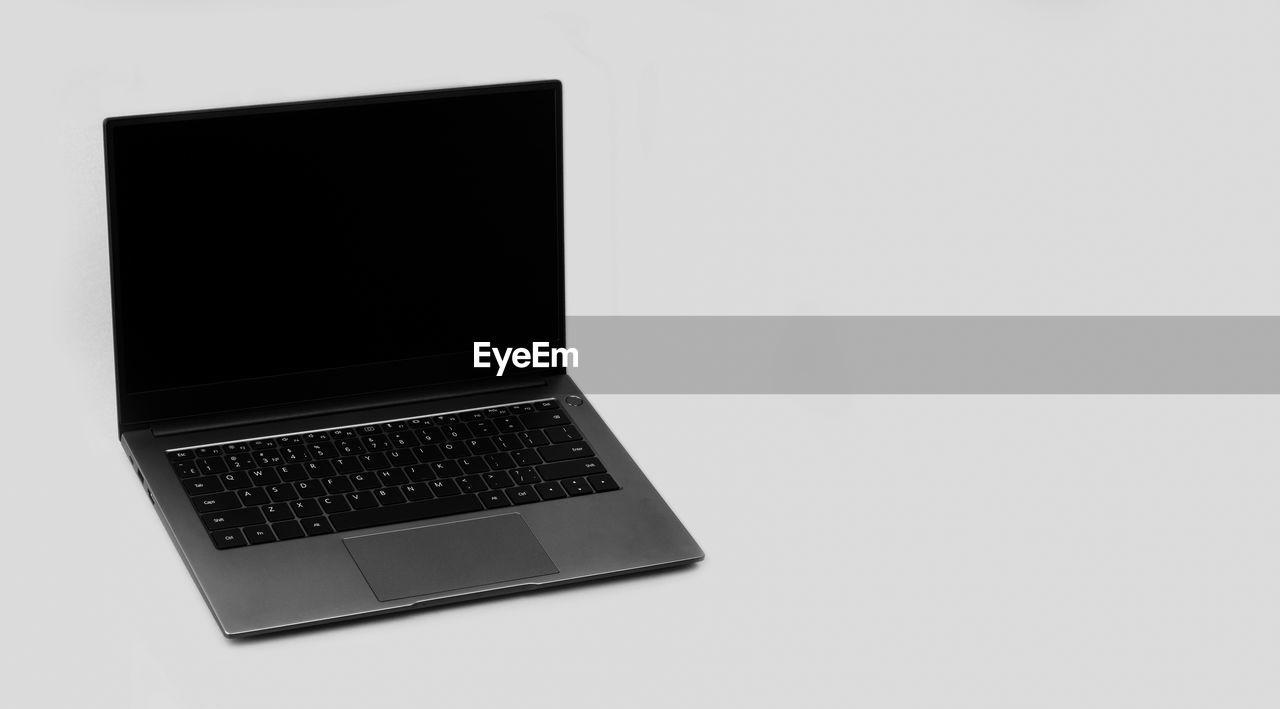 Laptop on a grey background with a copy space