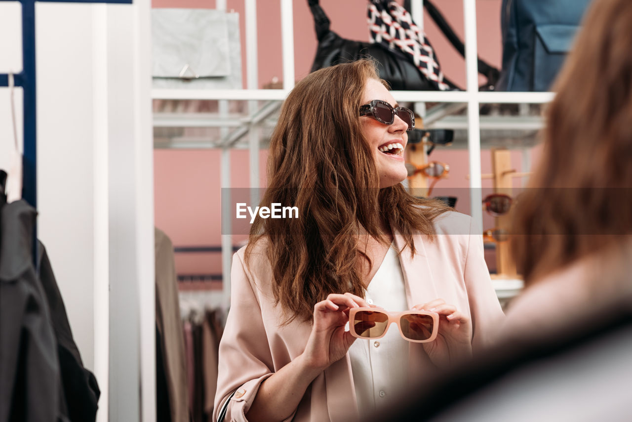 Young woman wearing sunglasses at store