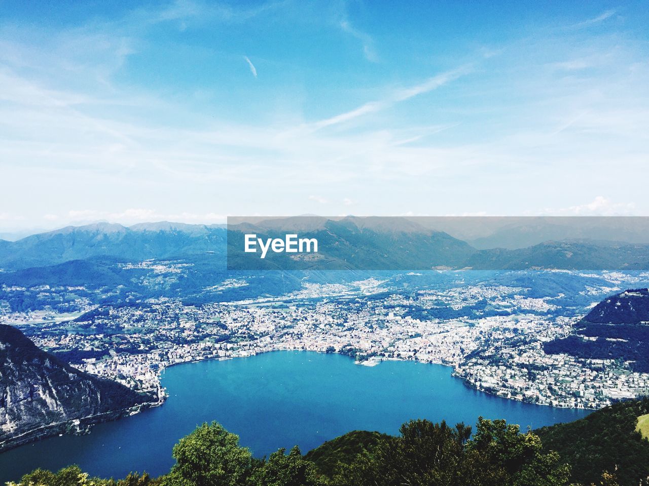 High angle view of sea and mountains against sky