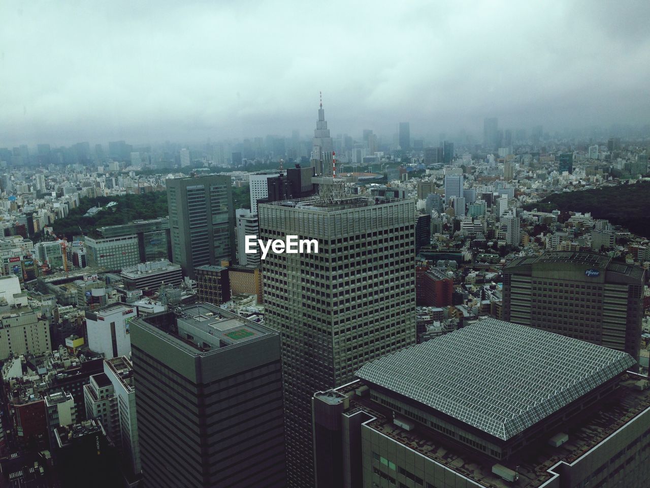 High angle view of buildings against cloudy sky