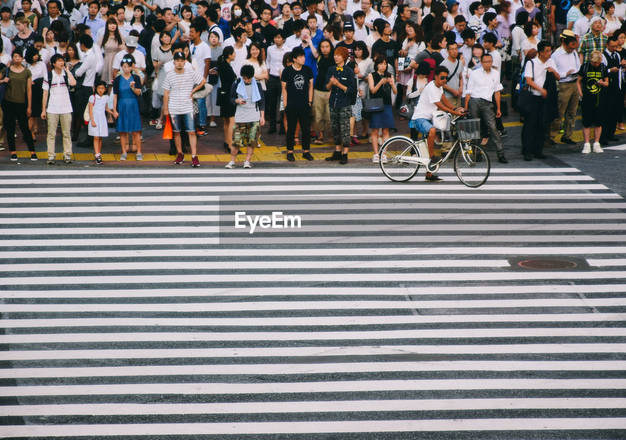 People waiting at zebra crossing 