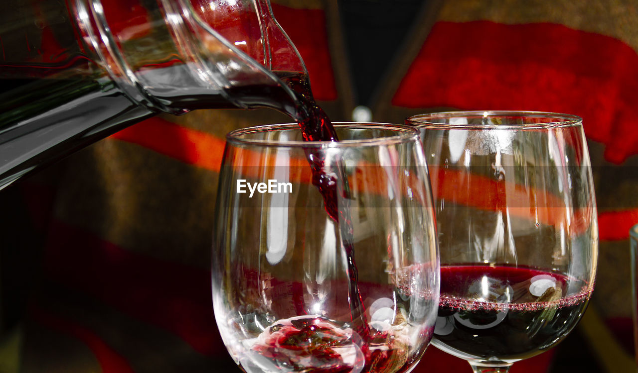 Two glasses with red wine close-up on a dark background