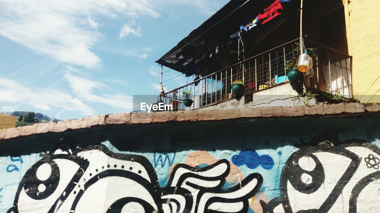 LOW ANGLE VIEW OF GRAFFITI ON WALL