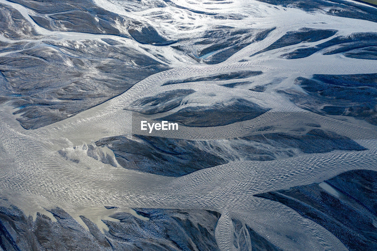 HIGH ANGLE VIEW OF SNOWCAPPED MOUNTAINS