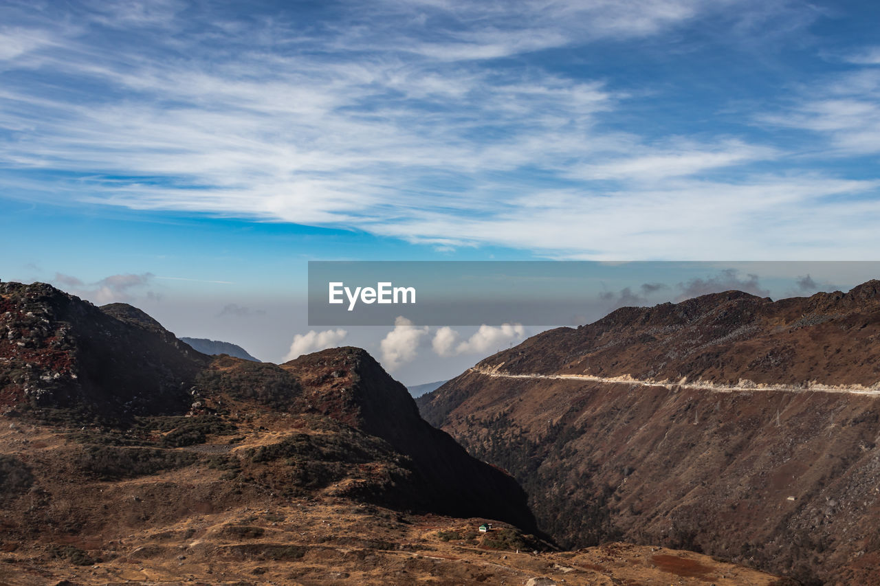 Himalayan breathtaking landscape with bright blue sky and twisty adventurous valley road