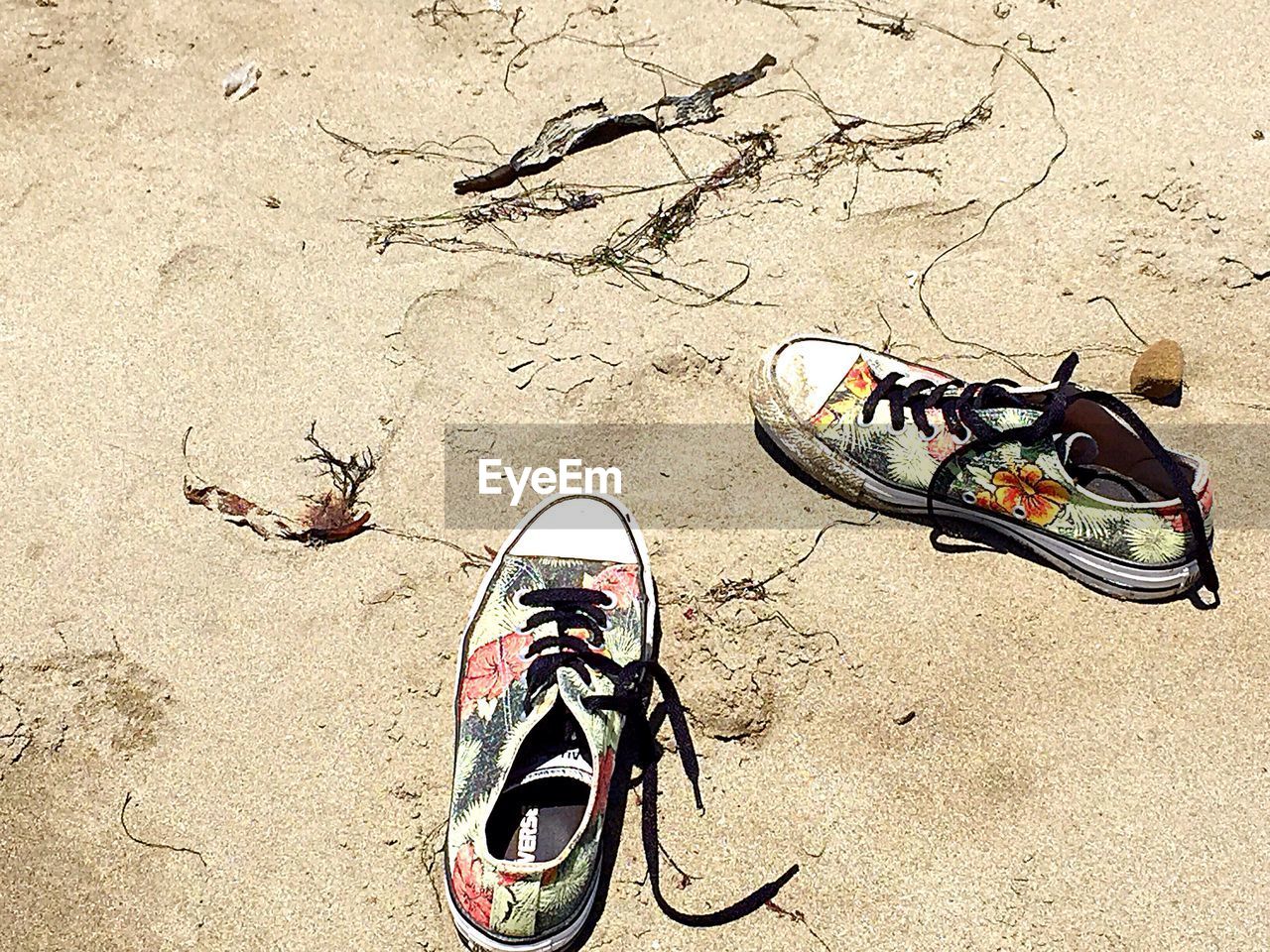 HIGH ANGLE VIEW OF BICYCLES ON SAND