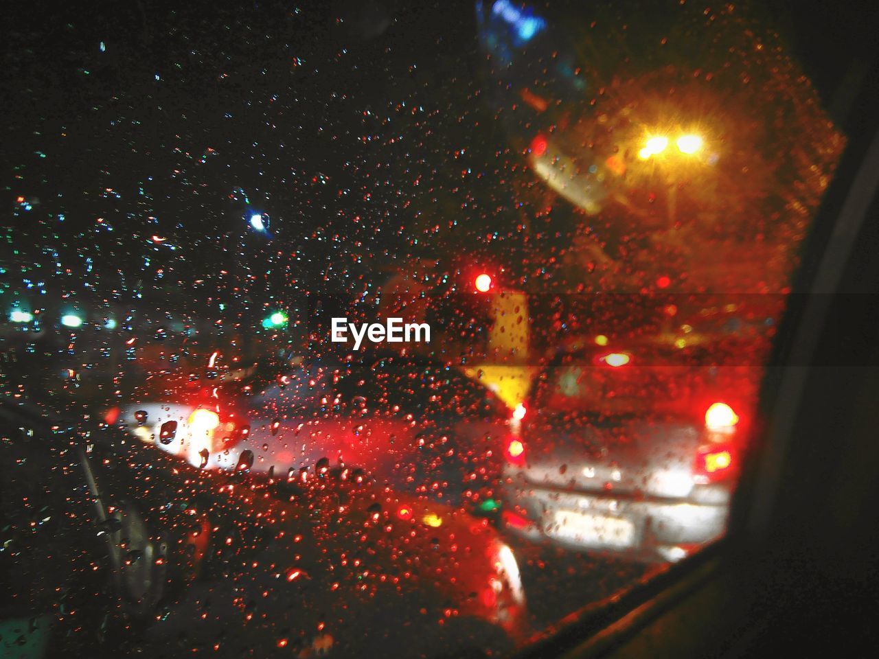 Raindrops on glass window at night