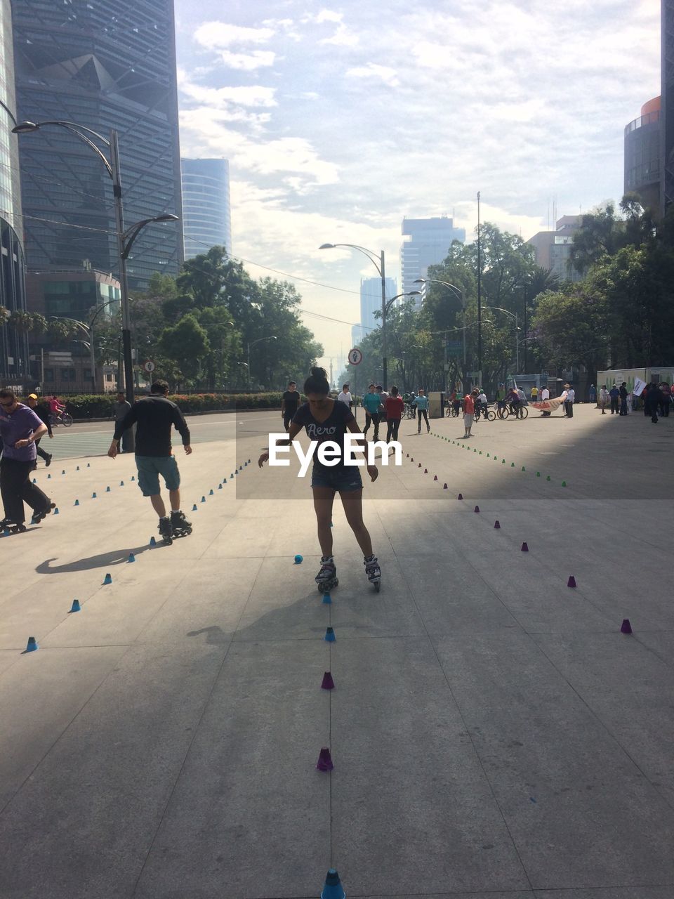 People roller skating on street in city