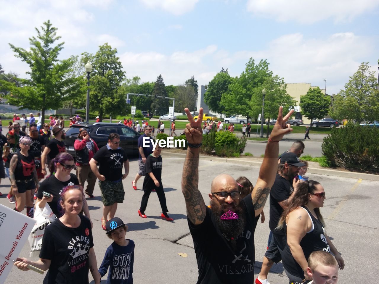 PEOPLE ON ROAD AGAINST TREES