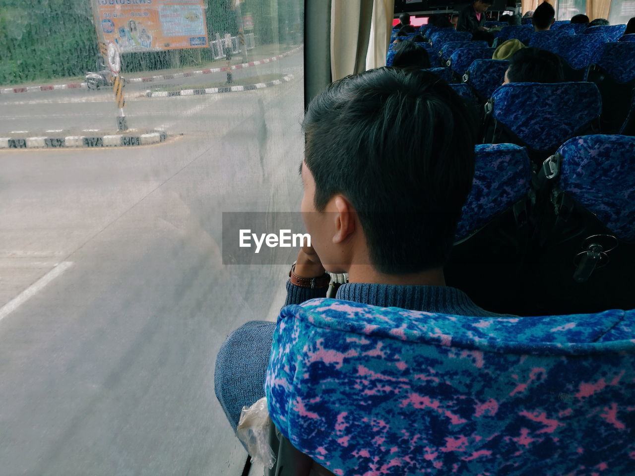 Rear view of man sitting in bus