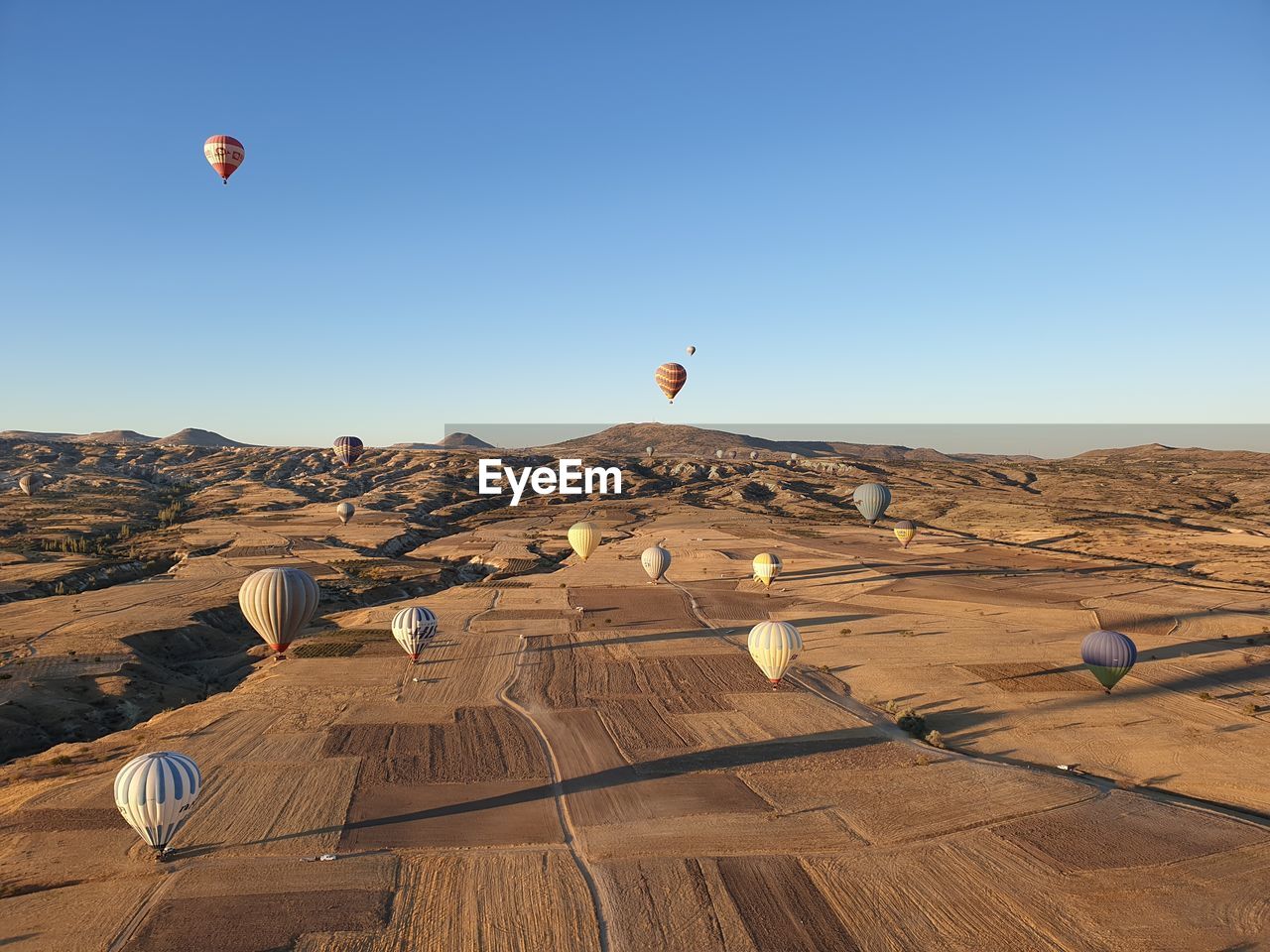 VIEW OF HOT AIR BALLOON FLYING OVER LAND