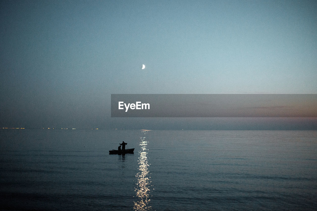 Scenic view of sea against sky at night